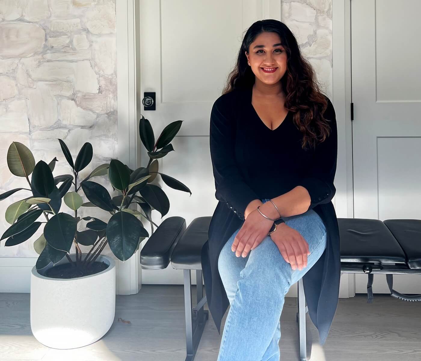 Dr. Manreet Hans seated in her clinic