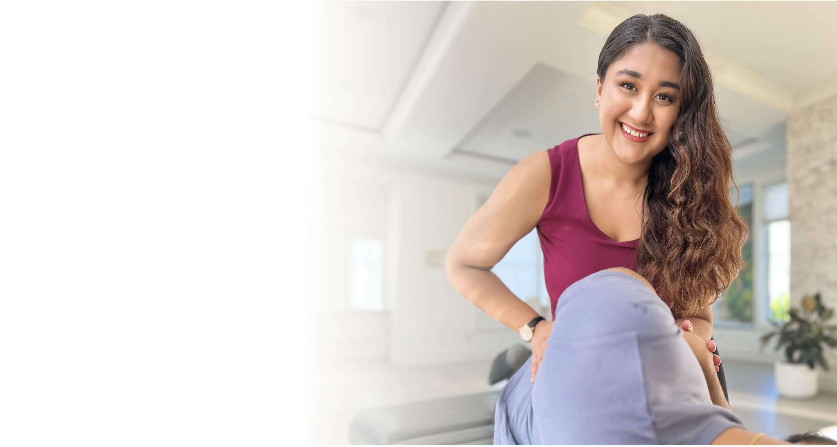 Dr. Manreet Hans treating a patient's knee in her Surrey clinic